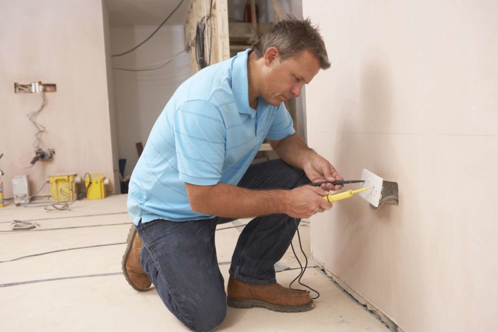 Professional Electrician Testing and Fixing Electrical Outlet
